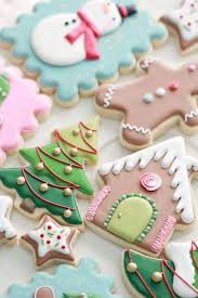 This royal icing dries nice and firm, so you can easily stock the cookies, wrap them, whatever your preference and transport them. Christmas Cookie Icing Christmas Tree Gingerbread Man House Shaped Cookies Placed On Whit Cookie Decorating Cookie Decorating Icing Christmas Cookies Decorated