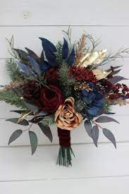 By andrea fowler floral arrangements are one of the best ways to bring your wedding color palette to life, so it's important to know what hues you want. Winter Bouquet Burgundy Navy Blue Gold Bouquet Faux Cones Bouquet Classic Wedding Burgundy Silk Flowers Boho Wedding Pampas Grass In 2021 Gold Wedding Flowers Burgundy Wedding Flowers Blue Wedding Bouquet