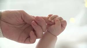 Mother and newborn daughter. Hand in ...