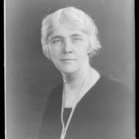 Flora Payne Whitney Miller, three-quarter length portrait, seated at  typewriter, facing front]