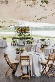 This Tented Wedding Reception With Wood Flooring Gray Linens And Cushions On The Folding Chairs Is Perf Wedding Tent Decorations Tent Decorations Tent Wedding