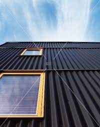 Living4media House Facade With Black Corrugated Metal Cladding And Light Wooden Windows Facade House Corrugated Metal Siding House Cladding