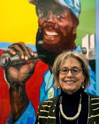 Leslie Kamil with the work of her late husband and U of M professor Jon  Onye Lockard at the grand opening of The University of Michigan's Afro  American Multicultural Lounge