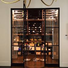 And with glass storage racks, two drawers, and storage for up to nine bottles in a wine rack, this piece is perfect for tucking away all your favorites. Dallas Texas Wine Cellar Requires Large Cooling Units Because Of Huge Storage Capacity And Glass Doors