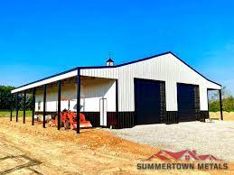 White pole barn with black roof. Farm Ag Buildings
