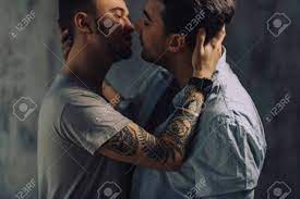 Sensual Gay Males Giving Deep Kiss, Embracing, Feeling Passion And Love,  Posing Isolated Over Grey Studio Wall, Close Up. Stock Photo, Picture and  Royalty Free Image. Image 152453183.