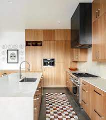 Employing a stone backsplash, sand colored tile flooring and a naturally light wood tones, this bright kitchen also features a constellation of recessed lighting. 5 White Marble And Wood Kitchens We Love