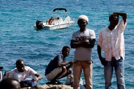 Photos: Holiday-makers are unfazed by migrants straggling onto their beaches
