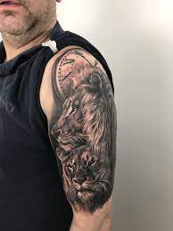 Lion Family Tattoo By Stefan Limited Availability At Newtestamenttattoo Studio Lioness Tattoo Lion And Lioness Tattoo Clock Tattoo Sleeve