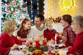 Look no further for christmas recipes and dinner ideas. Family With Children Eating Christmas Dinner At Fireplace And Decorated Xmas Tree Parents Grandparents And Kids At Festive Meal Winter Holidays Celebration And Food Kids Open Presents And Gifts Stock Photo Picture