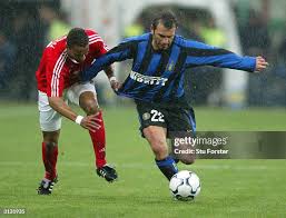 Inter milan player Buruk Okan has his shirt pulled by Benfica... News Photo 