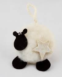 He is wearing a red bell on a red ribbon. Romney Marsh Wools Handmade Christmas Sheep Decoration Online Shop