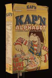 The cereals are made of letters from the alphabet. The Prop Gallery Kap N Alphabet Cereal Box