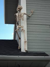 Almost Up This Is The Skeleton Over The Garage Roof Climbing The Side Of Our Second Story It Was Super Wind Halloween Decorations Halloween House Halloween