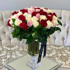 75 multicolor roses in a gl vase