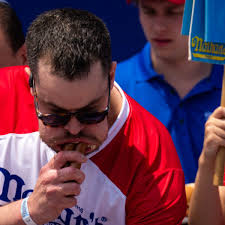 Patrick Bertoletti devours the competition to win hot dog eating contest