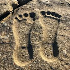 Who left massive footprints in solid stone?