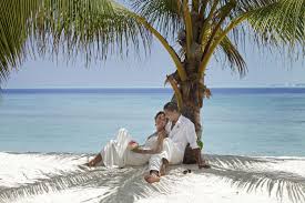 Relaxing Under A Palm Tree After Renewing Their Vows At Kandooma Maldives Maldives Wedding Ocean Wedding Maldives
