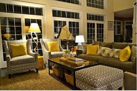 Shades of light gray on the floors, chairs, and cabinets pick up the light beautifully without the stark effect that too much light can have on a room with white furniture and walls. Yellow And Gray Rooms Yellow Living Room Grey And Yellow Living Room Living Room Color Schemes