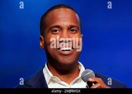 In this June 8, 2018 photo, John Cerna poses for a portrait by a mural of  Carlos Fonseca, national hero and founder of the Sandinista National  Liberation Front, at the Autonomous University
