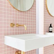 A contemporary pink bathroom clad with pink tiles in a herringbone pattern, gold fixtures and frames for a glam look. Pink And Gold Bathroom Ideas Houzz