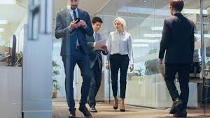 Low Angle Shot Of The Business People Walking Through The Corporate Building Stock Footage Business People Angle Shot Low Angle Shot Business People Low Angle