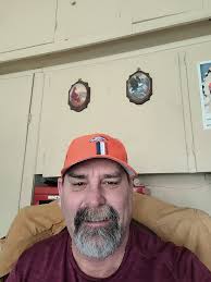 At the end of a media broadcast: "And for Randy Roe, I'm Dana Doe". Forget  gender. How do we parse this? I think of it as broadcast-speak shorthand  for "For Randy Roe