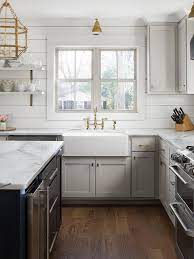 Some kitchens are colorful and bold with wooden counter tops, bright blue cabinetry, and polished nickel accents. Light Gray Shaker Cabinets With Black Island Cottage Kitchen