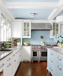 White Kitchen With Pastel Blue Cabinets And Tiles Cottage Kitchen Cabinets White Kitchen Design Cottage Kitchen Design