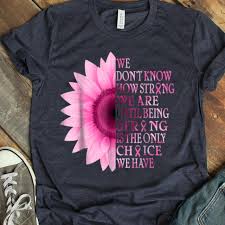 Bottle of thistle essential oil with thistle flowers on wooden background. Being Strong Pink Flower Breast Cancer Awareness Shirt Hoodie Sweater Longsleeve T Shirt