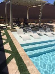 Custom Swimming Pool With Tanning Ledge With Loungers Pergola And Custom Integrated Grass Combo Decking Pool Houses Swimming Pool Designs Pool Lounge