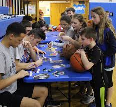 Varsity basketball players 'meet and greet' young fans