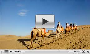 Riding camels in the desert. Echoing Sand Mountain Mingsha Shan Dunhuang Gansu