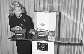 A woman demonstrating how to use the first commercial microwave ...