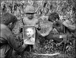 An Officer Of The 1st Cavalry Holding The Picture Of The North Vietnamese Communist Leader Ho