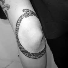 In this black and grey piece, a snake winds itself around some deer antlers to find its own tail. Top 73 Ouroboros Tattoo Ideas 2021 Inspiration Guide