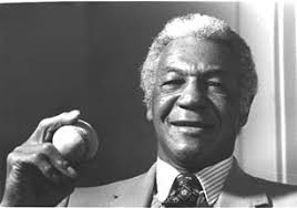John "Buck" O'Neil holding a baseball