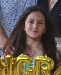 Can someone please create a formal piano recital poster photo with this  girl's face, possibly next to a piano? TIA!!