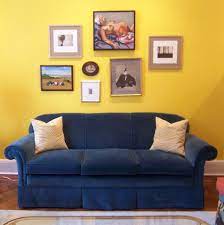 Blue Sofa With Yellow Art Wall Yellow Walls Living Room Yellow Living Room Blue Sofa Design