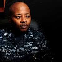 Lt. j.g. Blair Johnson explains the propulsion system of Swift to Capt. de  Navio Evelio Ramirez and Capt. de Fragata Cristian Estay.