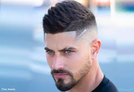 The side has a low fade over the ears, with a line differentiating the top part from the side part. 15 Faux Hawk Fade Haircuts For Stylish Men In 2021