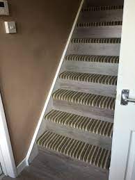 Mixture Of Striped Carpet And Laminate Stairs For A Nice Transition From Upstairs To Downstairs Carpet And Laminate Stairs Laminate Stairs Carpet Stairs