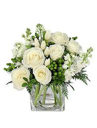 Beautiful Winter Flower Arrangement With Cedar Holly White Roses White Stock And Gre Winter Flower Arrangements White Flower Arrangements Rose Arrangements