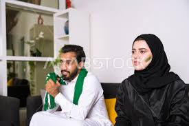 Welcome to al ahly sc official facebook page الصفحة الرسمية للنادى الأهلى المصرى نادي القرن الإفريقي. A Saudi Couple Watches The Saudi League Match Both Of Them Support Al Ahly And Saudi Arabia Photo 2715 Stock Photos Exclusive Gulf Arab Photos Stock Photography High Resolution Images Arabsstock