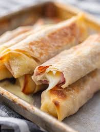 Baked Ham And Cheese Mozzarella Sticks Link Is Hard To Follow Use Egg Roll Wrappers Brushed With Olive Oil Fill Ham And Cheese Recipes Cheese Sticks Recipe