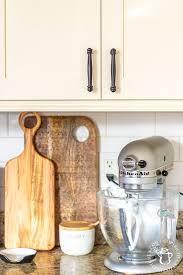 Mix milk paint thoroughly, and begin painting by using slanted brush to paint any detailed parts of doors that roller will not easily reach or cover. Diy Painting Our Kitchen Cabinets With White Milk Paint Catz In The Kitchen