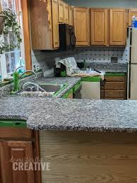 This blogger did and made it look like faux marble! How To Update Kitchen Counters Without Replacing Them Domestically Creative