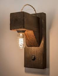 Seeded glass and straightforward metal hardware make this wall sconce a versatile design that's sure to fit right in with your rustic or coastal decor. The Hangman Wall Sconce Rustic Bathroom Lighting Rustic Wall Sconces Wood Lamps