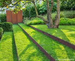 The Turf Steps And Corten Risers Draw Your Eye To The Feature Panels In Front Of The Yew Hedge Sloped Garden Garden Ideas Uk Landscape Stairs