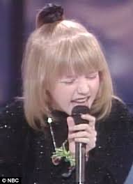 Christina Aguilera cringes as footage of her performing